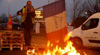 France drops fuel tax hike as "yellow vest" anger persists