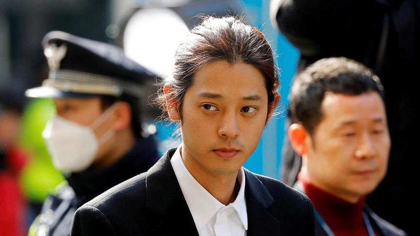 FILE PHOTO: South Korean singer Jung Joon-young arrives for questioning on accusations of illicitly taping and sharing sex videos on social media, at the Seoul Metropolitan Police Agency in Seoul, South Korea, Mar 14, 2019. REUTERS